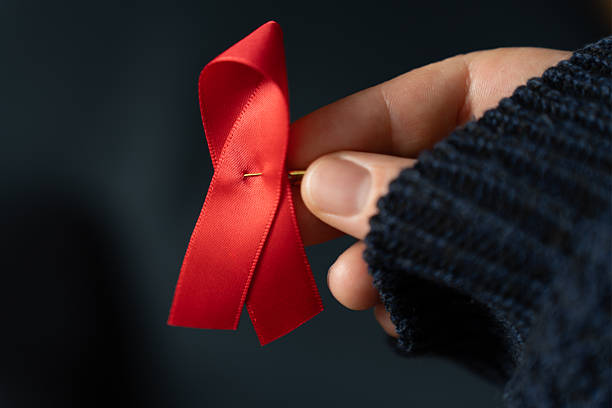 istock Dark background with red ribbon for the World AIDS awareness 2247316467