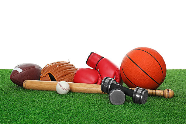 istock Different sport equipment on green grass against white background 2247316571