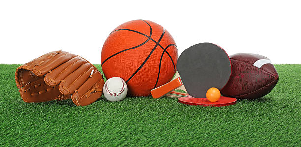 istock Different sport equipment on green grass against white background 2247316581