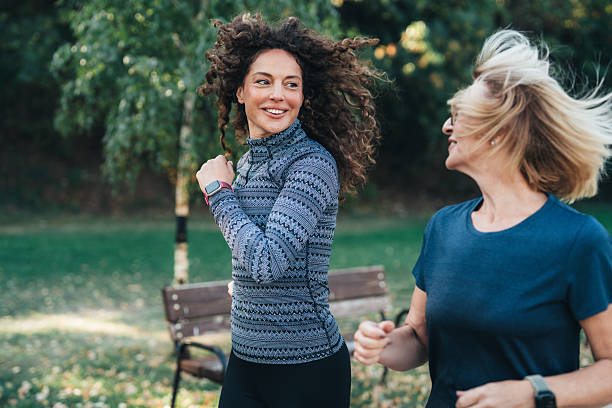 istock Joy in Every Step. Two female friends jogging in the park. 2247316824