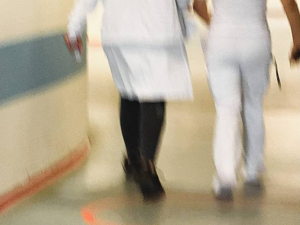 istock Medical staff walking through hospital corridor during busy shift 2247318807