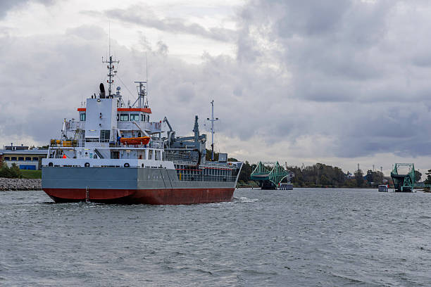 istock Cargo Ship Turning in Channel with Open Swing Bridge 2247319010
