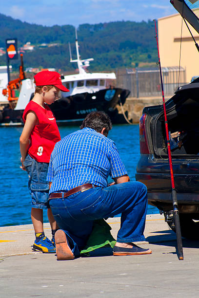 Father and son fishing at the Rio de La Plata, Argentina