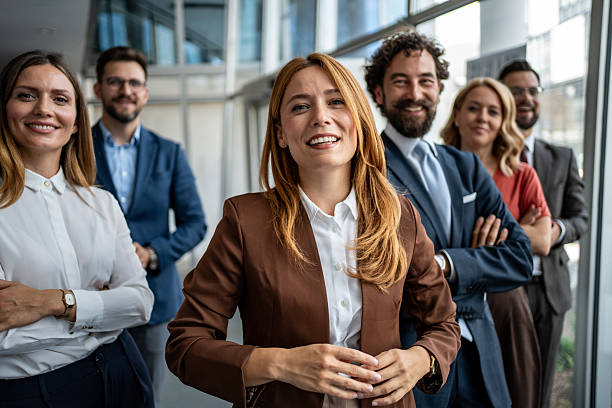 istock Diverse business team standing together in modern office 2247320536