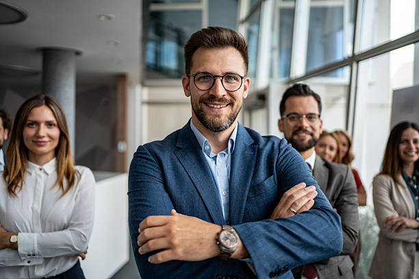 istock Business leader smiling with diverse corporate team in office 2247320612
