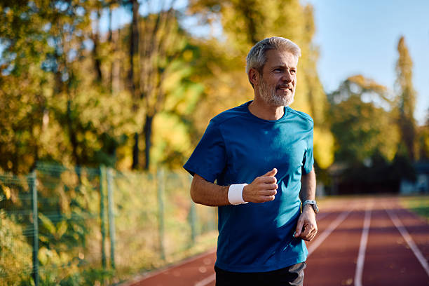 istock Happy mature athlete running in autumn park. 2247321317