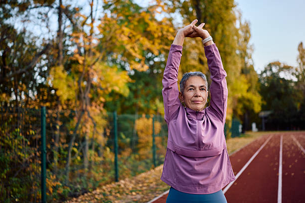 istock Mature athletic woman doing stretching exercises while working out outdoors. 2247321470
