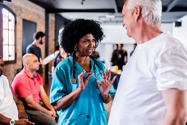 istock Nurse talking with patient at vaccination center 2247323295