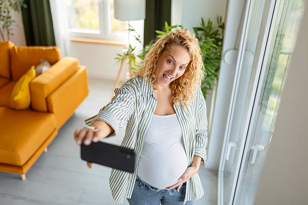 istock Future Mom Smiling While Snapping Photo of Herself 2247324006