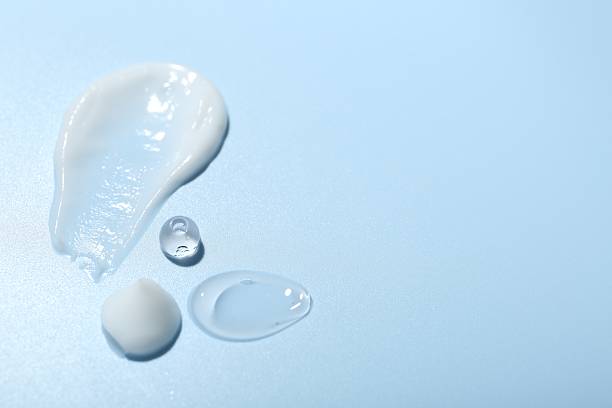 istock Cream and gel samples on light blue background, closeup. Space for text 2247324774