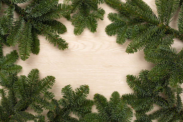 istock Christmas tree branches on wooden background, top view 2247324954