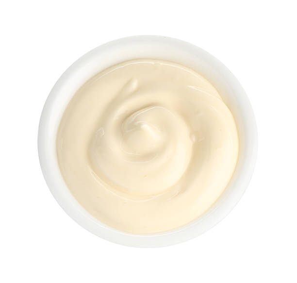 istock Tasty mayonnaise sauce in dish isolated on white, top view 2247325016