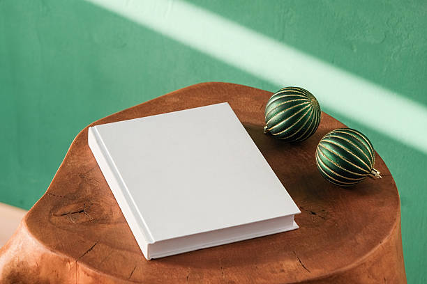 istock Blank book mockups with Christmas and New Year decorations on table with shadow 2247330344