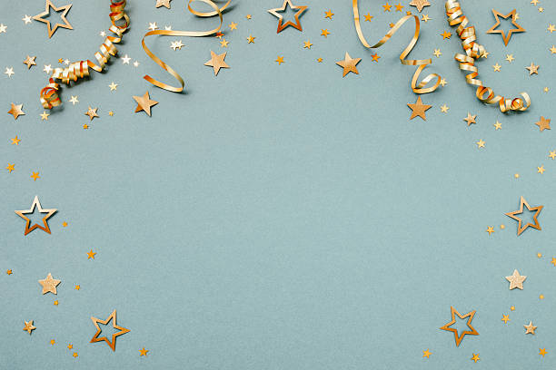 istock New Year, Christmas or birthday festive background top view. Celebration composition with golden confetti stars and serpentine party streamers. 2247330444