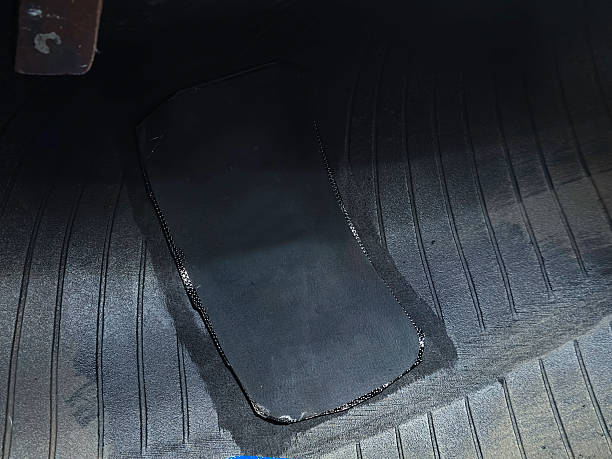 istock A patch is being made to a nail hole in a truck tire. 2247331863