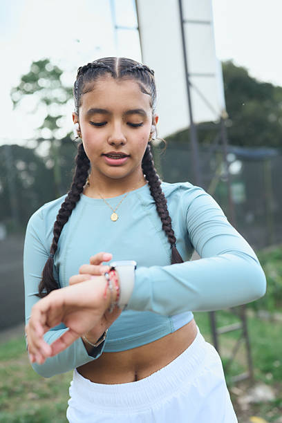 istock Young woman checking fitness data on smartwatch 2247333177