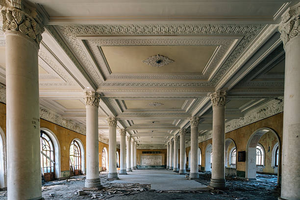 istock Abandoned neoclassical hall with marble columns and ornate ceiling, historic architecture with arched windows, retro textures, decay aesthetics and classical symmetry 2247336343