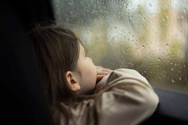 Little girl looking out from car window