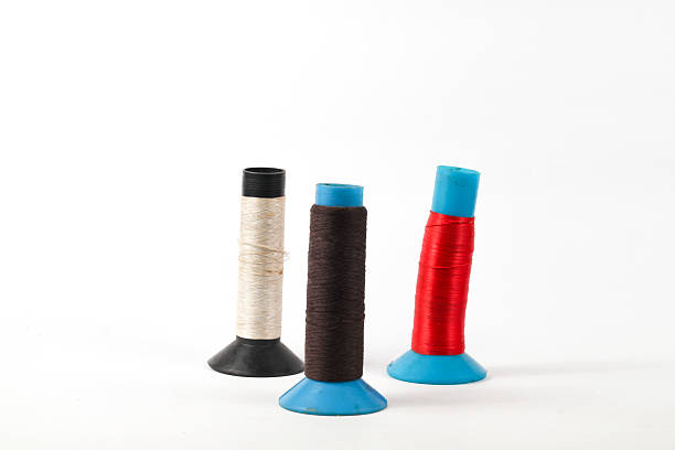 istock colorful thread spools in brown, red, and beige, ideal for sewing projects and creative design inspiration 2247340564