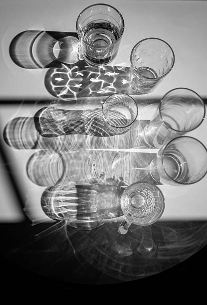 istock A black and white still life with glass tumblers, viewed from above, with beautifully patterned shadows. Conceptual photo. 2247342764