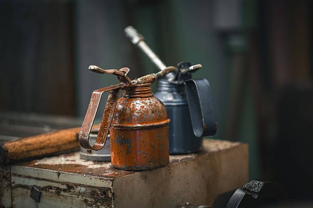 istock Two manual oilers on a bench by the mill in a metal workshop. 2247343150
