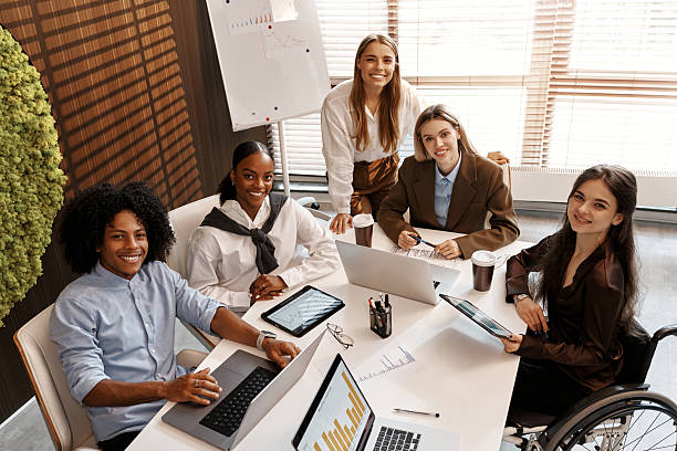 istock Diverse business team analyzing charts during office meeting from top view 2247344074