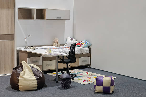 istock Children's bedroom with a bed, table and toys 2247344107