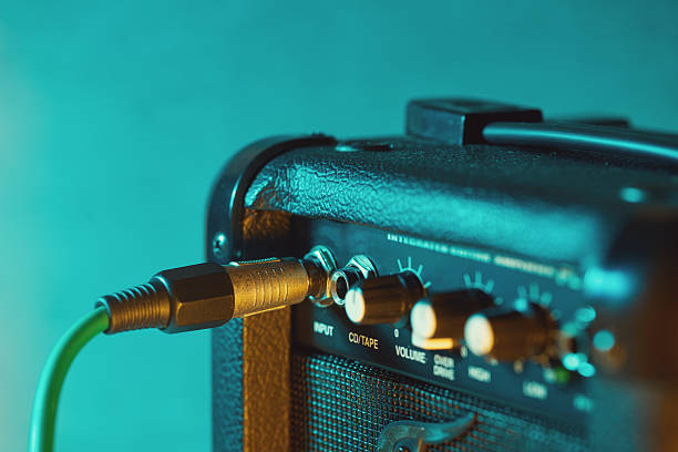 istock Guitar amplifier and knobs for adjusting sound levels 2247346560