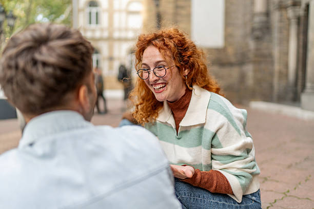 istock Happy young woman laughing talking with man 2247346599