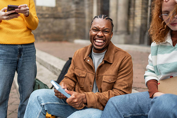 istock Male student expressing frustration with friends on campus 2247346668