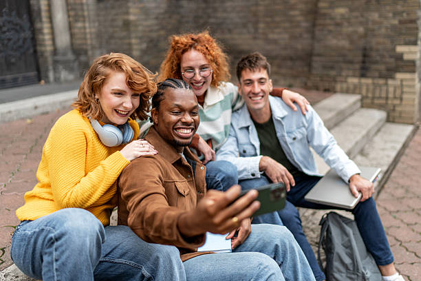 istock Diverse friends taking selfie on college campus steps 2247346713