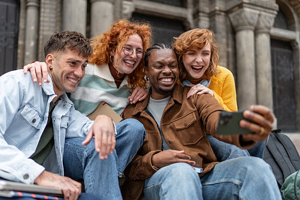 istock Diverse student friends taking selfie and laughing outdoors 2247346751