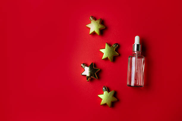 istock Serum on red background with golden star shaped decorations 2247347673