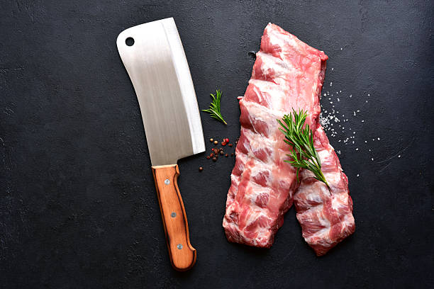 Raw pork ribs with ingredients for cooking. Top view with copy space.