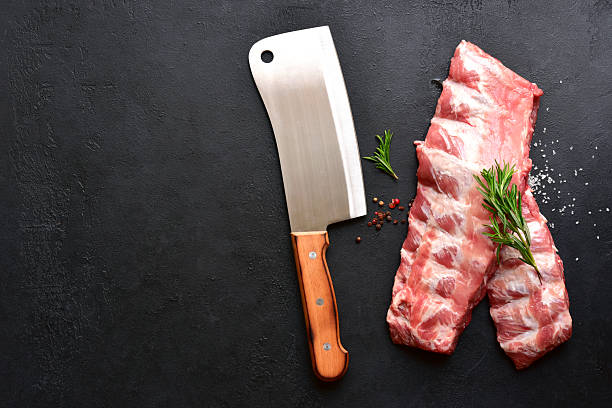 istock Raw pork ribs with ingredients for cooking. Top view with copy space. 2247349478