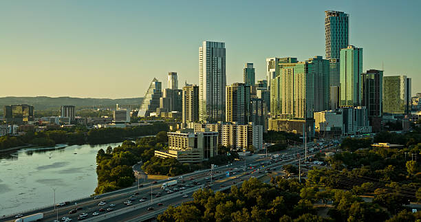 Aerial shot of Downtown Austin, Texas with Interstate 35 on one side, and Lady Bird Lake on the other at sunset. • Authorization was obtained from the FAA for this operation in restricted airspace.