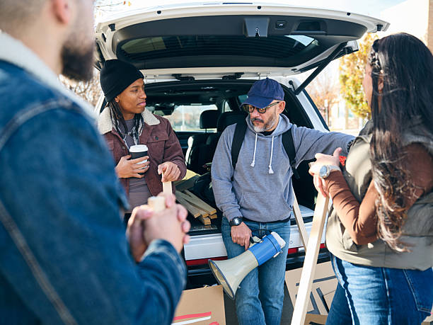 istock Group of people talking and preparing materials together during a community project outdoors 2247351018
