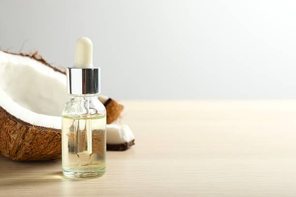 Serum bottle of coconut oil on table