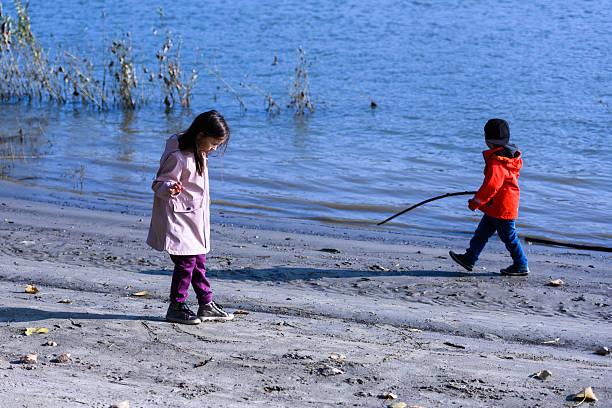 Young boy fishing from the shore of the Mississippi River on a summer morning.