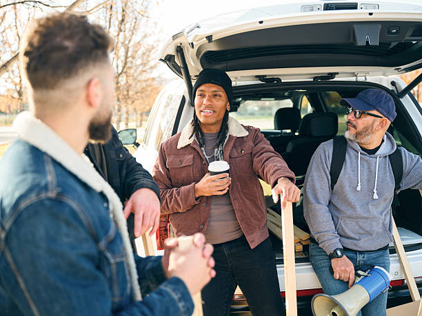 istock Group of people talking and preparing materials together during a community project outdoors 2247353965