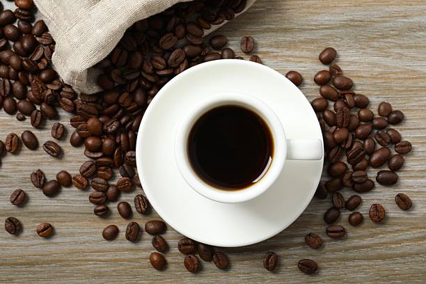 istock Black coffee with coffee beans on wooden background 2247354023