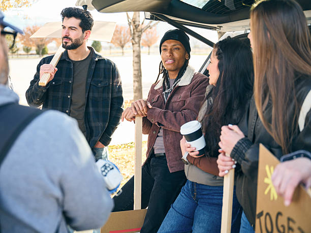 istock Group of people talking and preparing materials together during a community project outdoors 2247354087