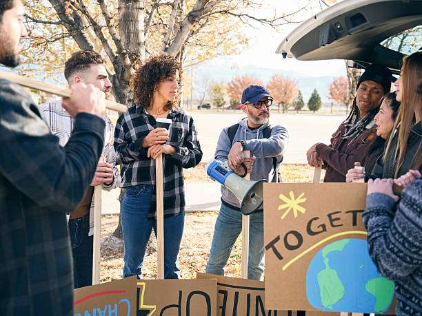 istock Group of people talking and preparing materials together during a community project outdoors 2247354112