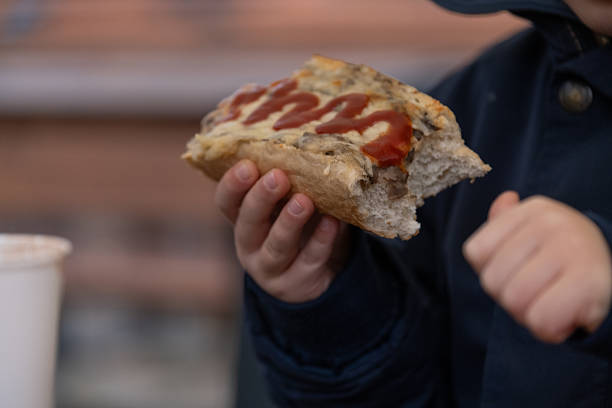 istock Child Holding Sandwich with Sauce Topping 2247354487