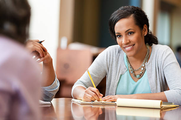 istock Smiling woman diligently taking notes during a collaborative meeting with a colleague. 2247357331