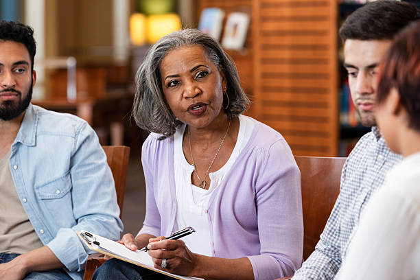 istock Diverse group engaging in counseling session with a mental health professional. 2247357335