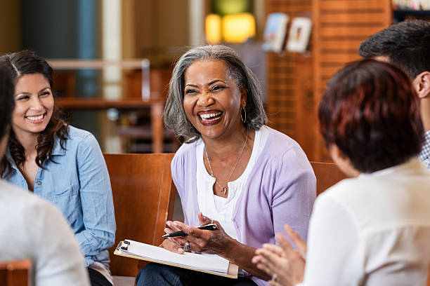 istock Diverse group laughing and talking during a meeting in a bright room 2247357341