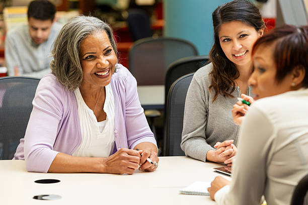 istock Diverse group of women engaged in a collaborative discussion around a table 2247357347