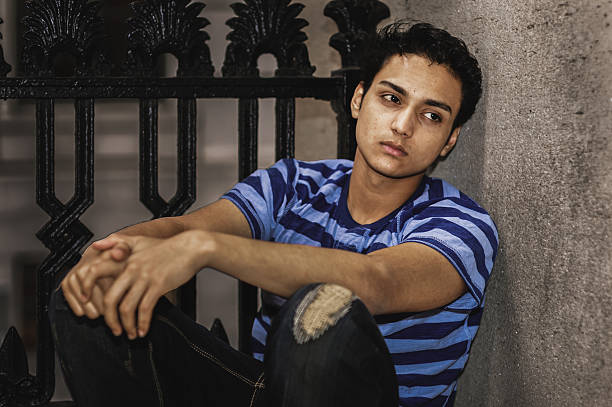 istock Pensive Young Man in Striped Shirt. 2247359192
