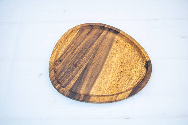 istock Empty wooden serving plate on white background for food presentation and product display 2247359279